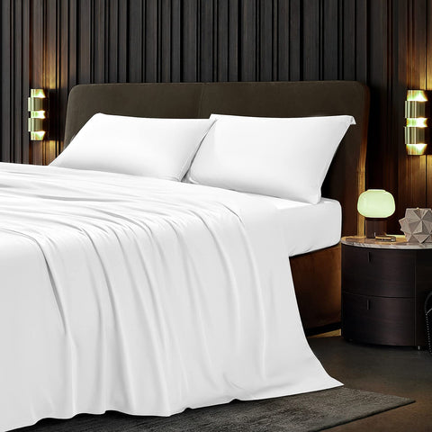 A bed with Protect-A-Bed Naturals Collection Tencel sheets and a wooden headboard, perfect for those with allergies.