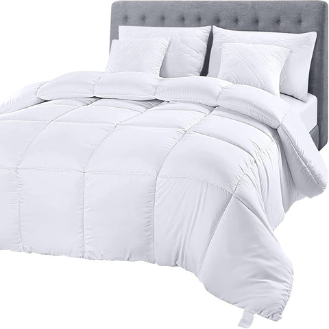 A white Downlite White Goose Down Duvet Insert | Midweight comforter on a bed.