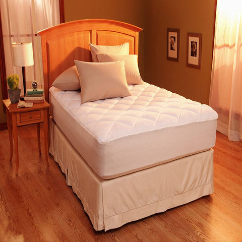 A Restful Nights Egyptian Cotton Mattress Pad with 300 thread count cotton sheets in a room with hardwood floors.