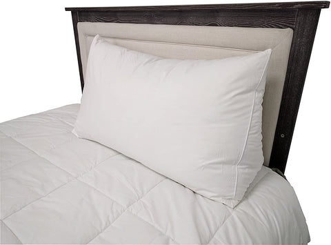 A white Pillowtex Reading Wedge Bed Pillow on a headboard.