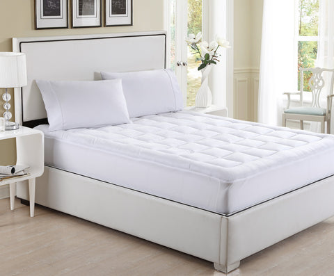 A white bed with a mattress on top, featuring a Carpenter Co. Slumberfresh Mattress Pad for added comfort.