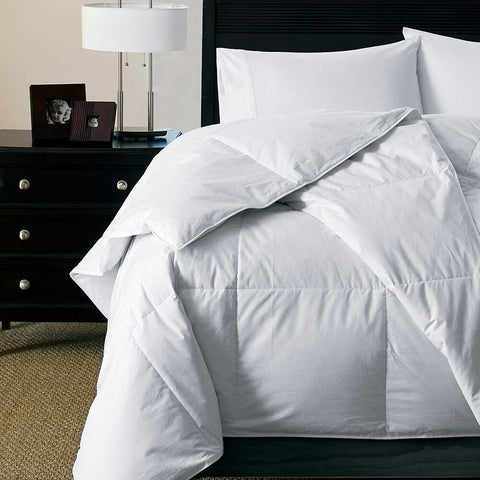 A Downlite White Goose Down Duvet Insert | Midweight on a bed in a bedroom.