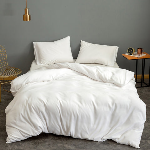 White Pillowtex Bamboo Duvet Cover for Weighted Blanket in a bedroom with grey walls.