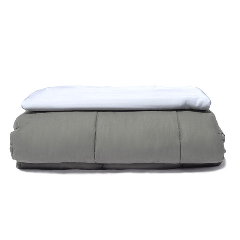 A grey and white Pillowtex Bamboo Duvet Cover for Weighted Blanket on top of a moisture-wicking white pillow.