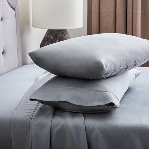A bed with eco-friendly Malouf Tencel pillow cases.