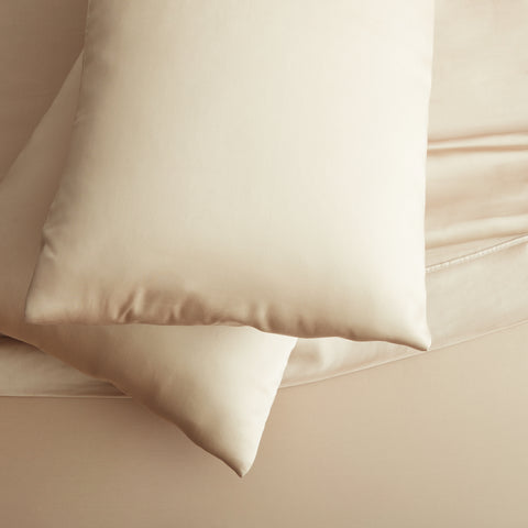 An eco-friendly bed with two Malouf Tencel Pillowcase Sets.