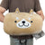 A man holding a Smiling Dog Face Muff hand warmer pillow by Milo The Dog, from Pillowtex.