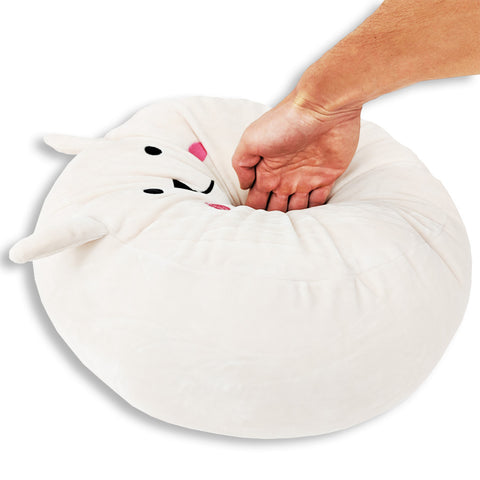 A person is touching a white Squishy Bunny Face Pillow with Floppy Ears from Pillowtex named Snowball the Bunny.