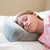 A girl sleeping on a Tommy The Cat Memory Foam Cat pillow by Pillowtex.