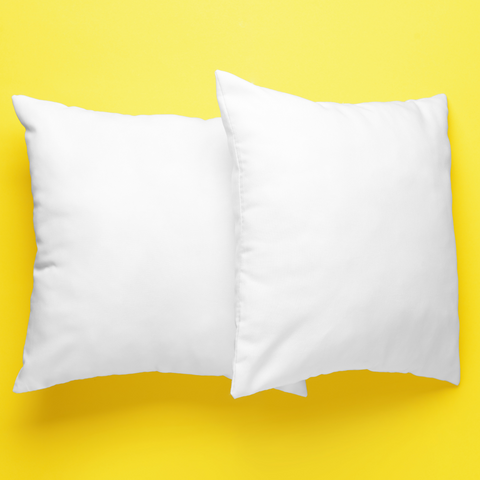 Two hypo-allergenic Pillow Factory Invista Performa Pillows on a yellow background.