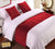 A bed with red Pillowtex Faux Suede Bed Scarf.