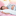 A woman sleeping on a Pillowtex Down Alternative Body Pillow in bed, receiving proper support.