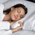 A peaceful woman enjoying a restful sleep, nestled in soft white bedding with her head resting on a Stearns & Foster Down Halo Pillow™ | 600 Fill Power.