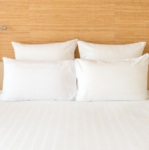 White hypoallergenic Pillowtex pillows on a bed in a hotel room.