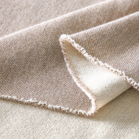 A close up of a Fairkind Soñando Alpaca Throw, hypoallergenic fabric.