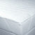 A close up of a Carpenter Contract Soft Flat Mattress Pad with Anchor Bands with a white cover.