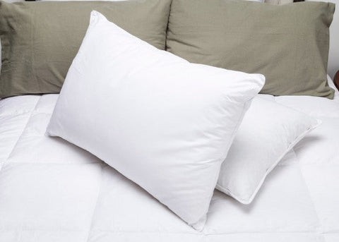 A Pacific Coast Feather Company Down Surround & Eco-Smart Pillow Combo Pack (Includes 2 Pillows) on the bed with a pillow protector.