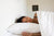 A woman laying in bed with a Down Etc. Diamond Support Feather & Down Pillow under her head.