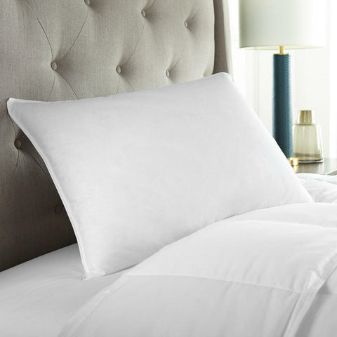 A Cloud Nine Comforts 50/50 White Duck Down & Feather Luxury Queen Pillow | Firm Support on a bed with a headboard.