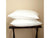 Two Downlite Spira® Cluster Down Alternative Pillows | Medium Support from Downlite are neatly stacked on a dark wooden luggage rack against a plain beige wall. The medium support pillows appear fluffy and are positioned symmetrically, one on top of the other, creating a clean and minimalist look.