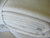 A white blanket made with Holy Lamb Organics Wool Moisture Barriers, perfect for your bed.