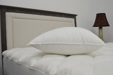 A JS Fiber "Ultra Down" 33oz. Soft Pillow | Standard Size is resting on the bed, providing comfort.
