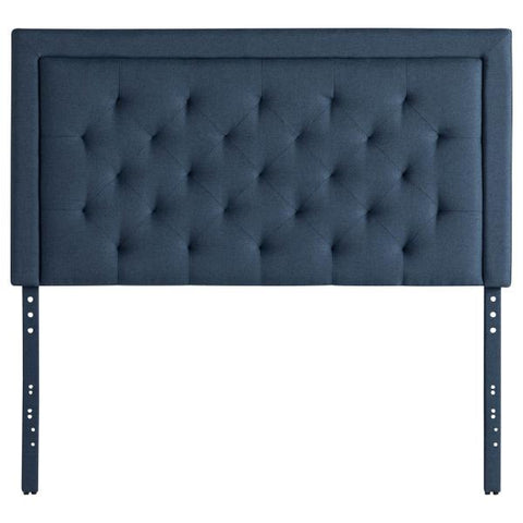 A timeless blue tufted Malouf Hennessey headboard with metal legs.