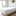 A white mattress on a wooden frame in a bedroom, protected by a Pillowtex Deluxe Mattress Protector.