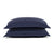 Two stacked navy blue pillows with a ruffled edge design and PureCare Cooling Bamboo pillow shams isolated on a white background, suggesting a comfortable and stylish addition to home bedding.