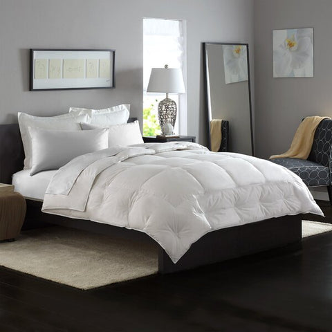 A Pacific Coast Feather Grandia Down Comforter in a bedroom.