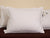 Two Pacific Coast Feather Tria Down & Feather Pillows by Pacific Coast Feather Company on a bed with tags on them.