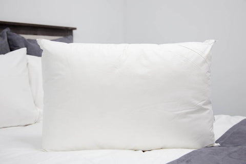 A supportive Pillowtex® Premium Polyester Pillow | Extra Firm on the bed for side sleepers.