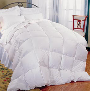 A Pillowtex Classic Weight Feather and Down Comforter on a bed in a bedroom.