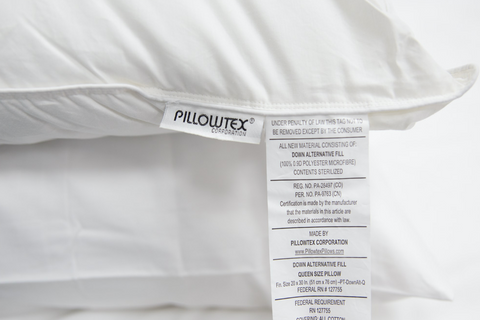 A firm white Pillowtex Down Alternative Pillow | Medium with a label on it.