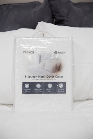 A Pillowtex Duvet Cover made of cotton on a bed.