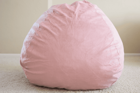 A pink Pillowtex Quality Kids Memory Foam Bean Bag with Washable Removable Cover 3ft resting on the floor.