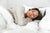 The woman is peacefully sleeping in a bed with white sheets and a Pillowtex Copper Infused Bamboo Pillowcase.