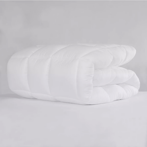 A cozy Pillowtex Classic Weight Down Alternative Comforter/ Duvet on a white background.