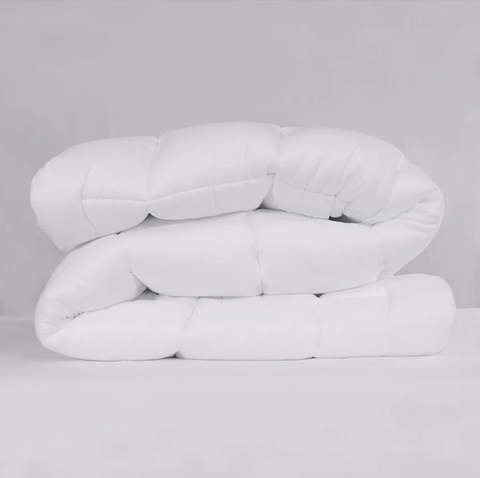 Two Pillowtex Classic Weight Down Alternative Comforters/ Duvets are stacked on top of each other for added warmth and comfort.