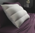 Two SHEEX 4 Channel Performance Density Pillows designed for side sleepers rest on a smooth, purple satin bedsheet, offering a contrast of comfort and luxury in a serene bedroom setting.