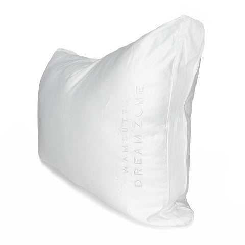 A soft, white, Wamsutta Dream Zone Synthetic Down Pillow with the words "dream zone" embroidered on it, isolated against a white background, suggesting comfort and restful sleep.